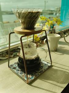a tea pot on a stand on a table at Longmen Seaview Resort Hotel in Huxi