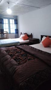 two beds in a room with at Country cottage in Nuwara Eliya