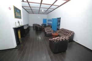 a waiting room with couches and chairs in a room at Country cottage in Nuwara Eliya