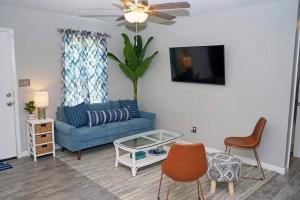 a living room with a blue couch and chairs at The Blue Pearl 6min to Downtown -Short Beach Drive in Pensacola