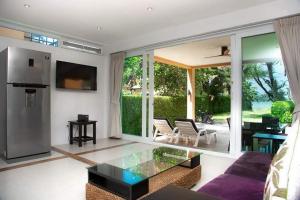 a living room with a glass coffee table at Siam Beach Villa 21D Koh Chang in Ko Chang