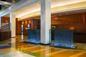 a lobby with two glass screens in a building at Renaissance ClubSport Aliso Viejo Laguna Beach Hotel in Aliso Viejo