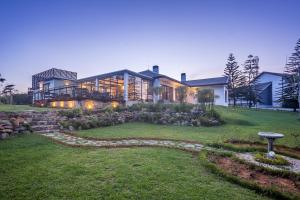 a large house with a large garden in front of it at Chimneys Nuwara Eliya in Nuwara Eliya