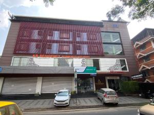 a building with two cars parked in front of it at KB RESIDENCY in Kozhikode