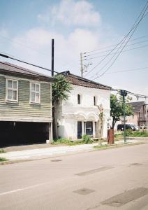 una vieja casa blanca en la esquina de una calle en Portside Inn Hakodate, en Hakodate