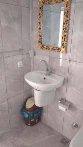 a bathroom with a sink and a mirror at Emre's Stone House in Goreme