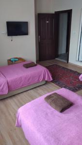 A bed or beds in a room at Emre's Stone House