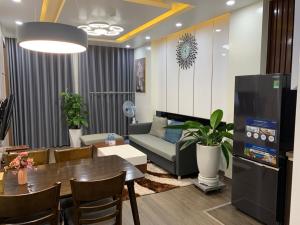 a living room with a table and a couch at BaoTran Apartment & hotel in Ðông Khê