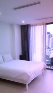 Giường trong phòng chung tại Scenia Bay Residence Nha Trang