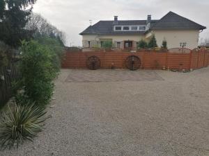 a house with a wooden fence in front of a yard at Haus Lupo am Kanal in Castrop-Rauxel