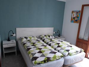 a bed with two pillows on it in a bedroom at Jormar in Port de Pollensa