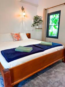 מיטה או מיטות בחדר ב-Jungle Vibes