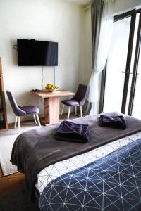 a bedroom with a bed and two chairs and a table at Belgrade Waterfront Comfortable Apartment in Belgrade