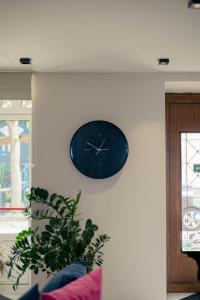 a blue clock on a wall in a living room at Hotel Kyani Akti in Xylokastron +72 photos