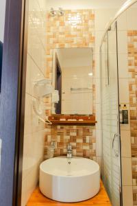 a bathroom with a sink and a mirror at Hotel Kyani Akti in Xylokastro +72 photos