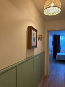 Zimmer mit einem Flur mit einem Bett und einer Lampe in der Unterkunft Studio avec accès plage et mer in Dinard