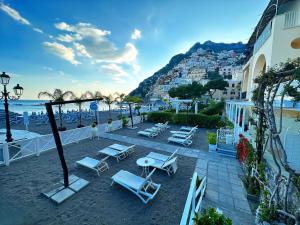 a group of chairs and tables on a beach at La Caravella di Positano - Relais & Beach in Positano