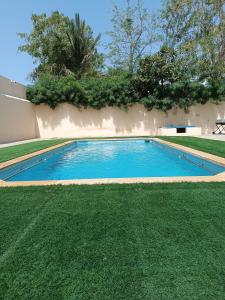 a swimming pool in the middle of a yard at Stay House in Dubai in Dubai