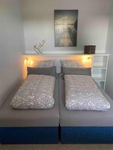 two beds in a room with lights on them at Sea Lodge Mardorf in Neustadt am Rübenberge