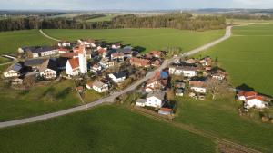 an aerial view of a village with houses and a road at Fewo beim Schmied Straßkirchen in Vogtareuth