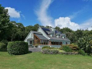 a house with a solar roof on top of it at Valhalla BnB in Kenmare