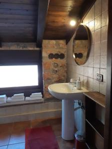 a bathroom with a sink and a mirror and a window at Holiday house Sicily in Borgetto