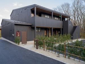 a black house with a fence in front of it at Rakuten STAY VILLA Nasu Standard Room pet allowed Capacity of 4 persons in Nasu-yumoto