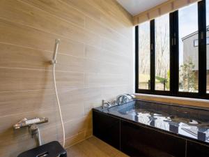 a bathroom with a bath tub and a window at Rakuten STAY VILLA Nasu Villa Capacity of 10 persons with Kitchen Tools Type No pet allowed in Nasu-yumoto