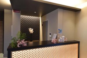 a reception desk in a lobby with a shower at Hotel Rokune in Nara