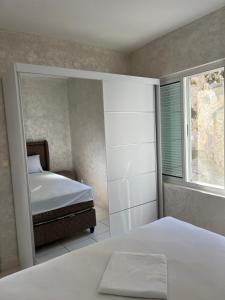 a bedroom with a bed and a window at Lake Skadar Paradise in Podgorica