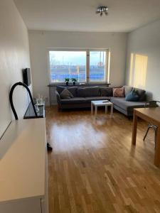 a living room with a couch and a table at Eurovision Finale 1BD in Malmö