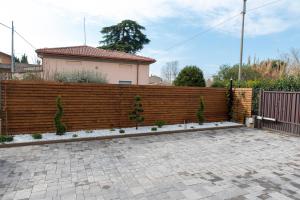 a wooden fence in front of a house at Casa di Zina in Verona