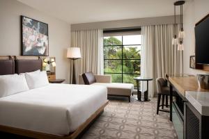 a hotel room with a bed and a large window at Epicurean Hotel, Autograph Collection in Tampa