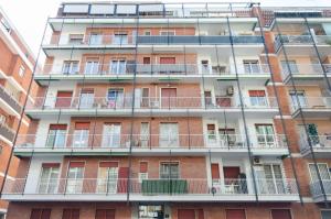 a tall building with balconies on the side of it at Vivimi Home Fiordalisi Stile & Comfort Vicino Metro in Milan