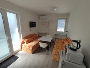 a living room with a couch and a table at BÖJTÖS apartmány NESVADY in Nesvady