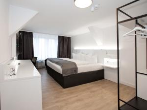 Postel nebo postele na pokoji v ubytování DORMERO Hotel Worms