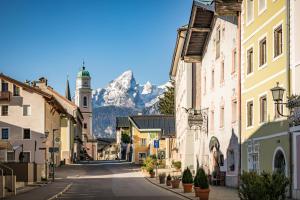 a street in a town with a mountain in the background at Ferienappartement Austen in Piding