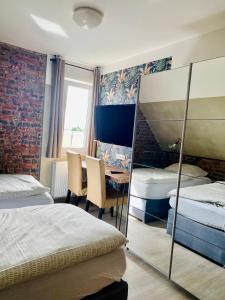 a bedroom with two beds and a table with chairs at PHOENIX Apartments - Monteurwohnung mit RIESIGER Parkfläche in Bielefeld