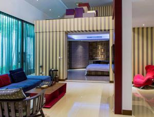 uma sala de estar com uma cama e um quarto com um sofá em All-Ur Boutique Motel - Tai Tung Branch em Taitung City