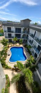 an aerial view of a large apartment building with a swimming pool at Ocean Breeze Apartment in Nadi