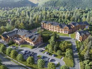 an aerial view of a large mansion in the mountains at Mövenpick Resort & Spa Karpacz in Karpacz