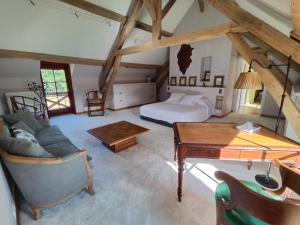 een slaapkamer met een bed en een bureau in een kamer bij Domaine du Grand Nouer in Pierrefitte-sur-Sauldre