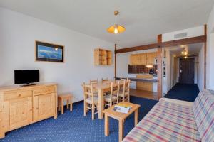 a living room and kitchen with a table and a couch at Cabourg - 20 - Appart belle expo - 6 pers in Les Deux Alpes