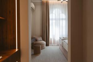 a bathroom with a toilet and a window at Astoria Grand Hotel in Oradea