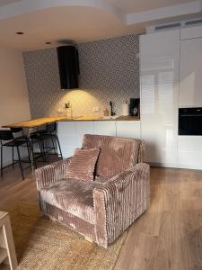 a living room with a couch and a kitchen at 4Seasons II in Stronie Śląskie