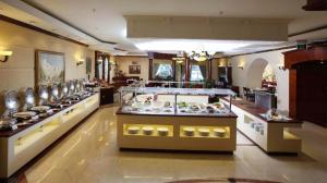 a buffet line in a restaurant with many dishes at Knight Castle Hotel - Formerly known as Carlton Palace Hotel in Dubai