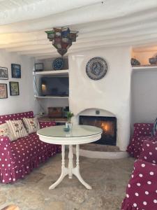 - un salon avec une table et une cheminée dans l'établissement Las casillas de la Villa: SOLEÁ, à Montefrío