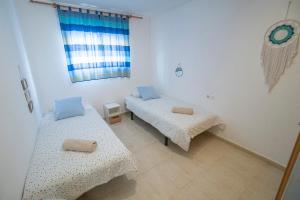 a room with two beds and a window at Apartamento-Loft con vistas in Vilafamés