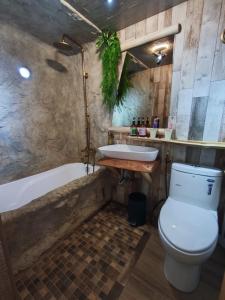 a bathroom with a toilet and a tub and a sink at 棚棚屋室內帳篷民宿Inn in Kaohsiung +54 photos