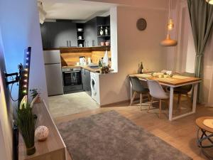 a kitchen and dining room with a table and chairs at Apartment Fiore in Smederevo
